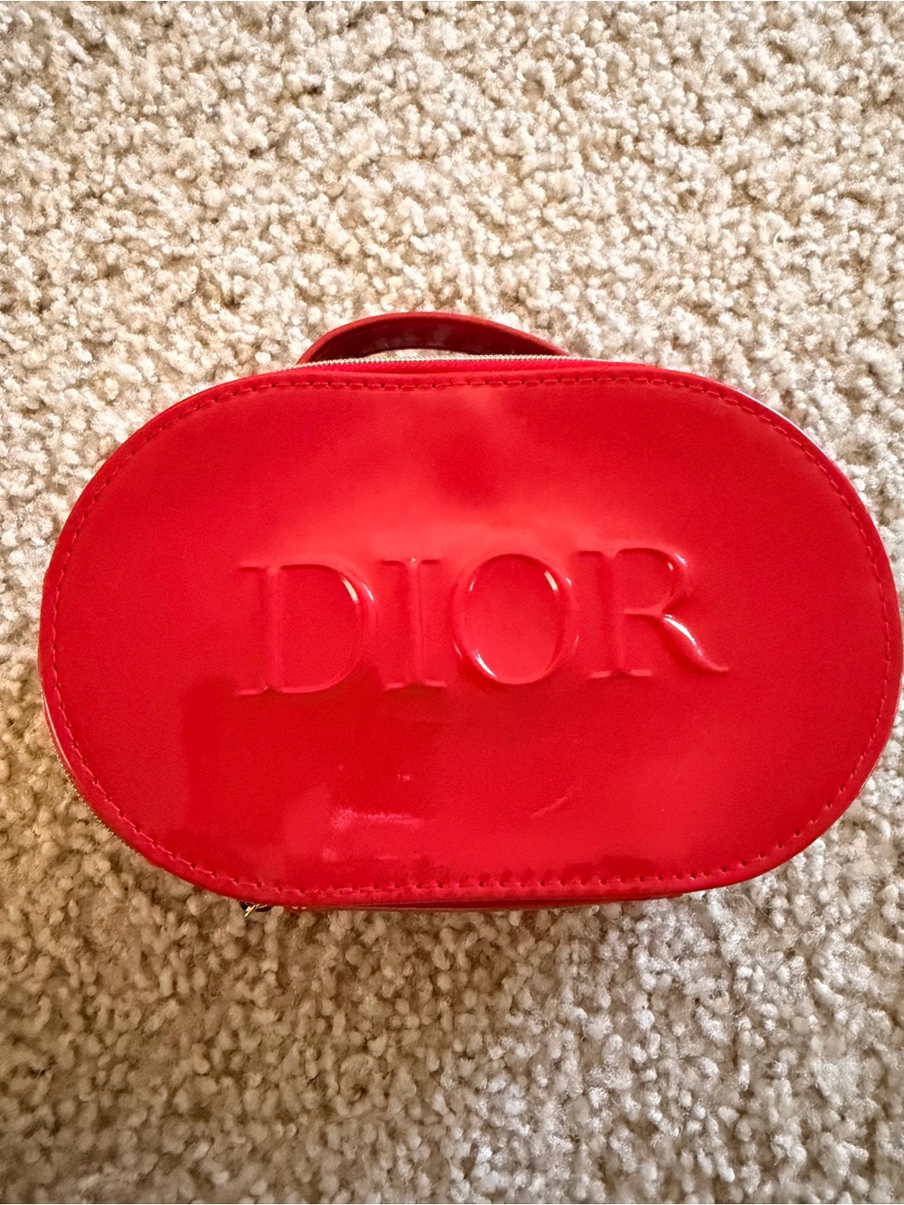 Dior Glossy Red Oval Cosmetic Case with Embossed Logo